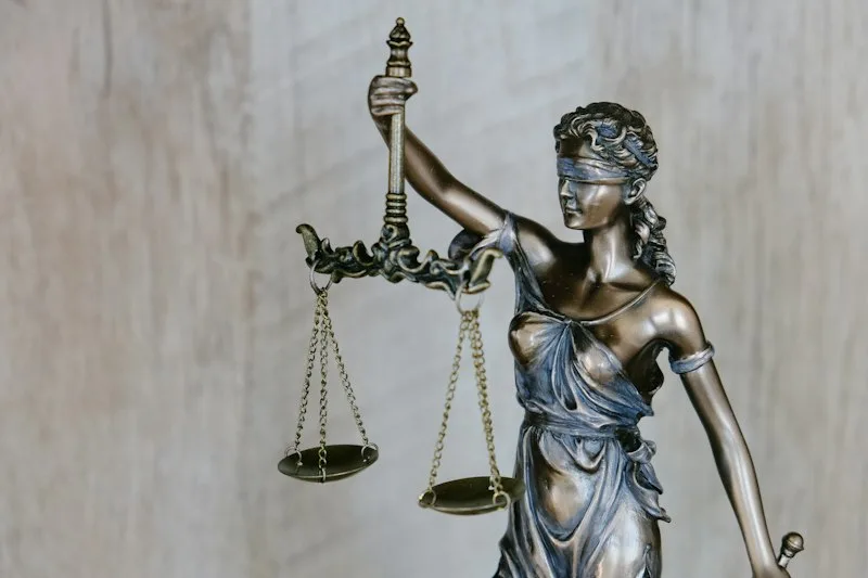 Statue of Lady Justice holding balanced scales representing UK legal safeguards and privacy rights