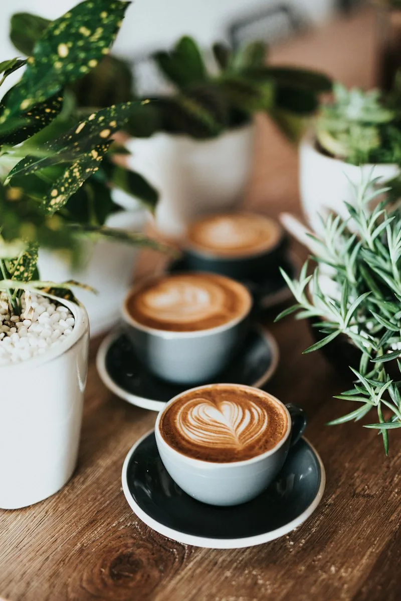 Warm ceramic coffee cups on wooden table in quiet cafe setting